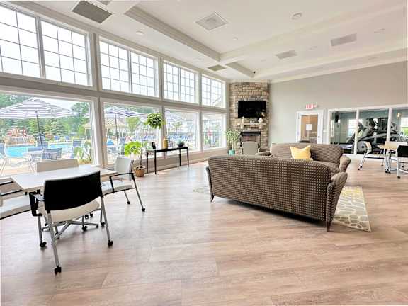 A modern kitchen with a grey sofa and a round table.