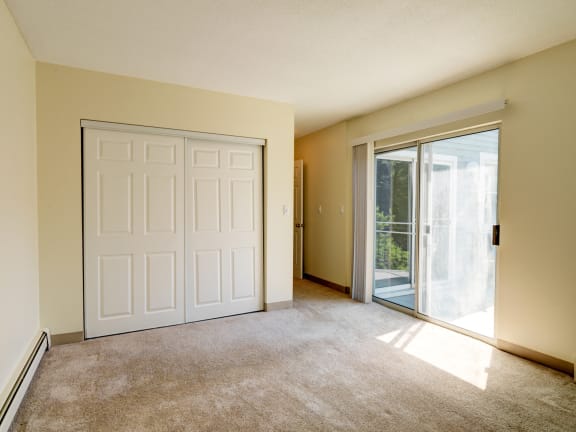 Bedroom with patio access at Blue Hills Village in Canton, MA