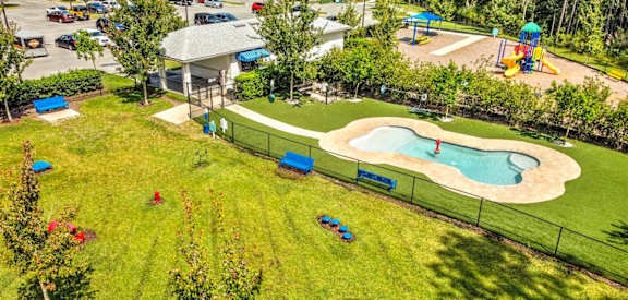 a backyard with a pool and grassy area at Palm Bay Club, Jacksonville