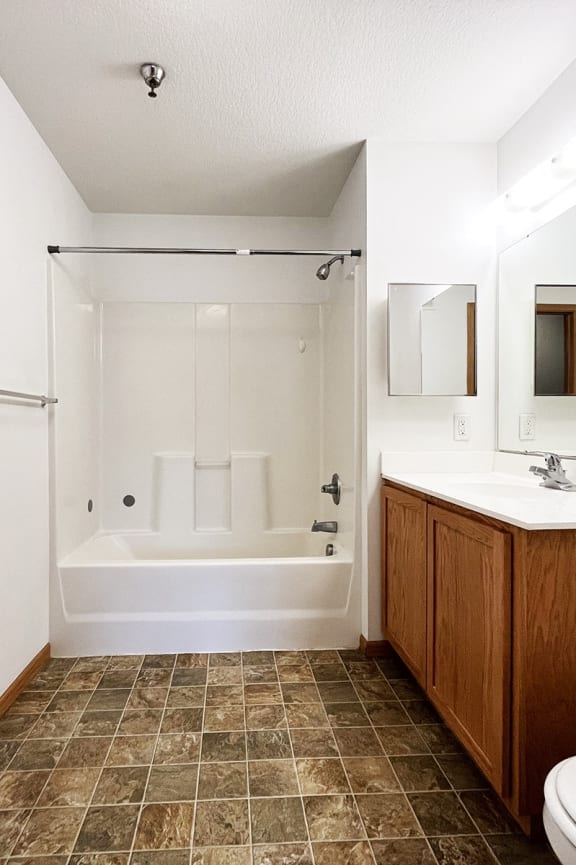 a bathroom with a toilet and a sink and a bath tub