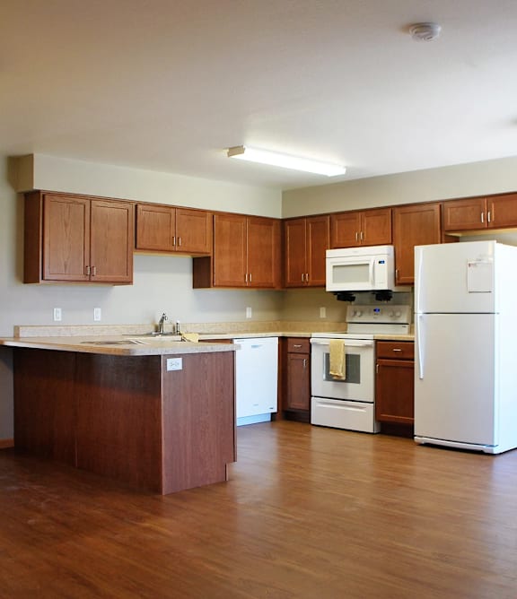A kitchen with wooden cabinets and a white refrigerator.