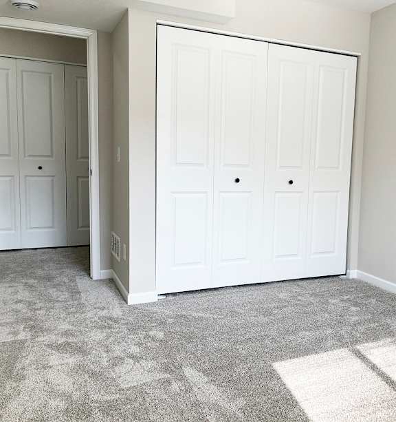 a bedroom with a bed and a ceiling fan