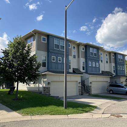 an apartment building with a car parked outside of it