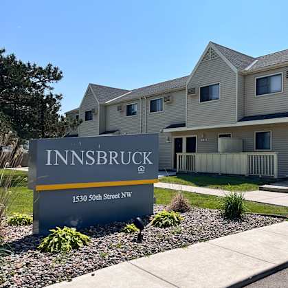 A sign for Innsbruck is in front of a building.