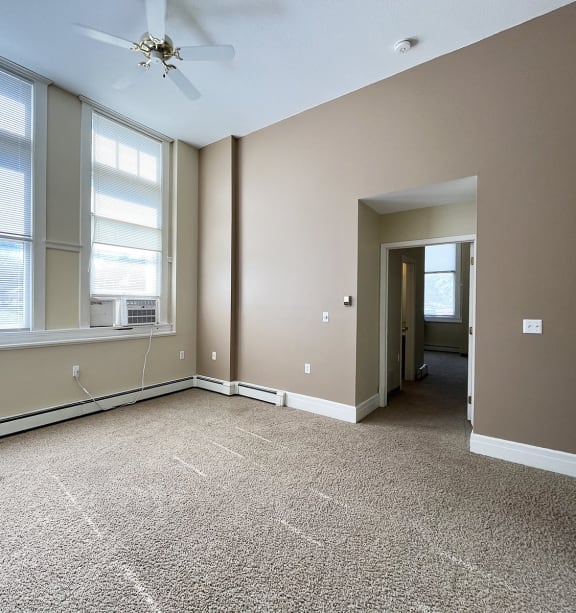 a bedroom with a bed and a ceiling fan
