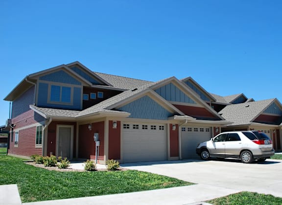 A house with a car parked in front.