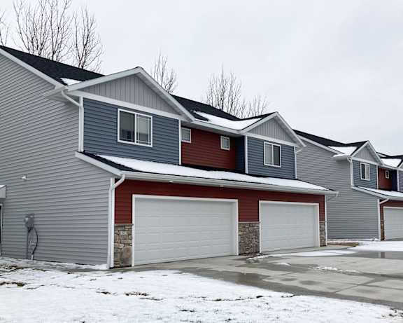 A row of houses with garages in front.
