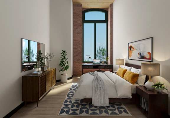 a bedroom with a bed and a dresser in front of a window