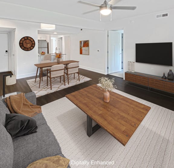 a living room with a couch and a television at Byron Lakes Apartments, Byron Center, MI, 49315