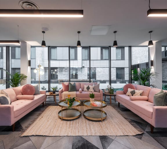 a room with a tv on the wall and rugs on the floor