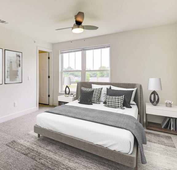 a bedroom with a bed and a ceiling fan  at Signature Pointe Apartment Homes, Athens, 35611