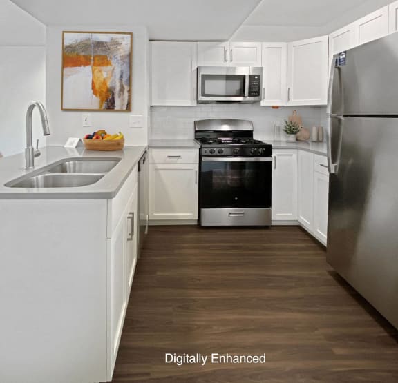 a bedroom with a bed and a ceiling fan at Byron Lakes Apartments, Byron Center