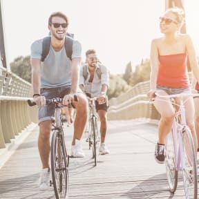 a group of people riding bikes on a bridge