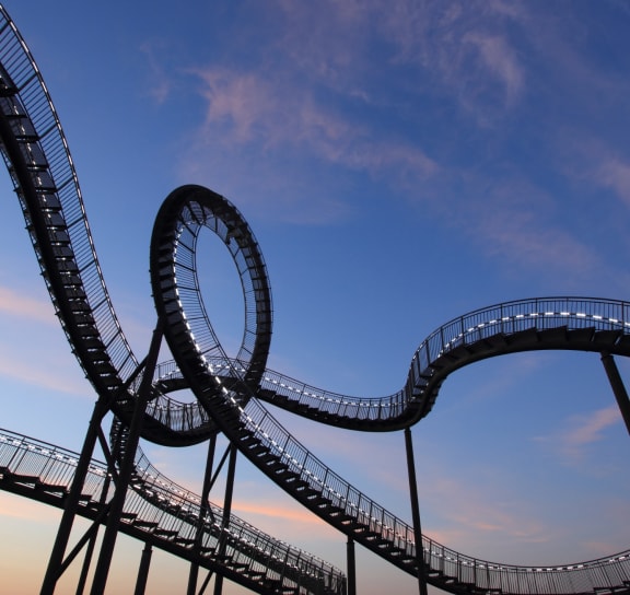 a roller coaster with a blue sky in the background