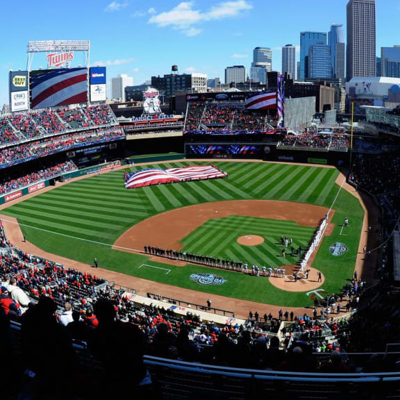 a crowd of people watching a baseball game at a stadium