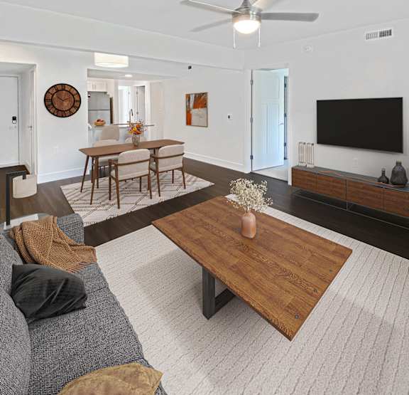 a living room with a couch and a television at Byron Lakes Apartments, Byron Center, MI, 49315