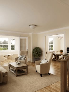 A living room with a chair, a table, and a plant.