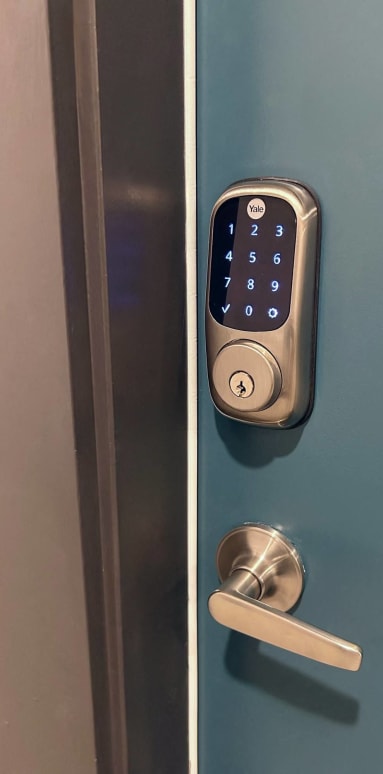 an open door with a smart lock on the door handle