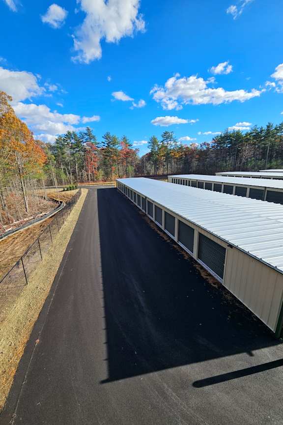 A train track stretches into the distance under a clear blue sky.