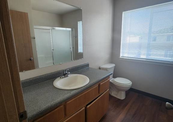 A hallway with a door and a mat on the floor.