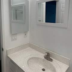 A bathroom with a sink and mirror.