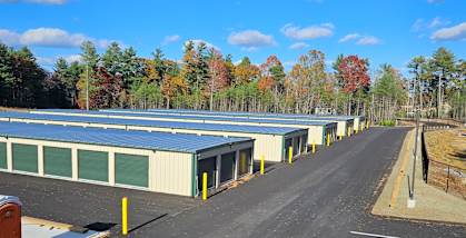 A parking lot with a blue sky and clouds in the background.