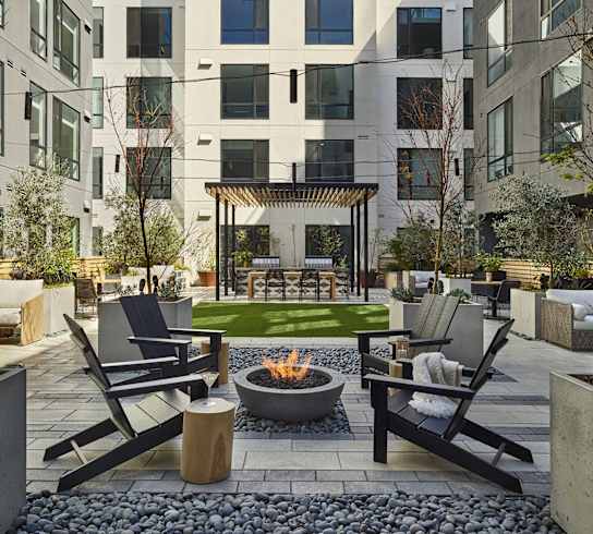 A modern building with a courtyard and seating area.