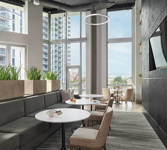 A modern dining area with a table and chairs.