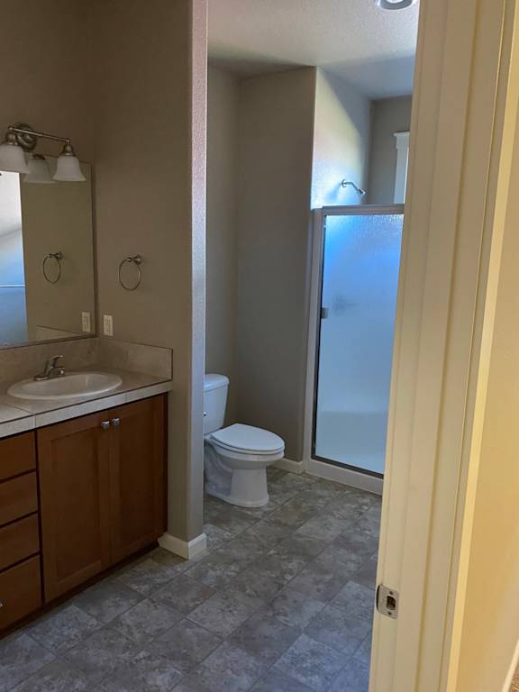 a bathroom with a toilet sink and shower