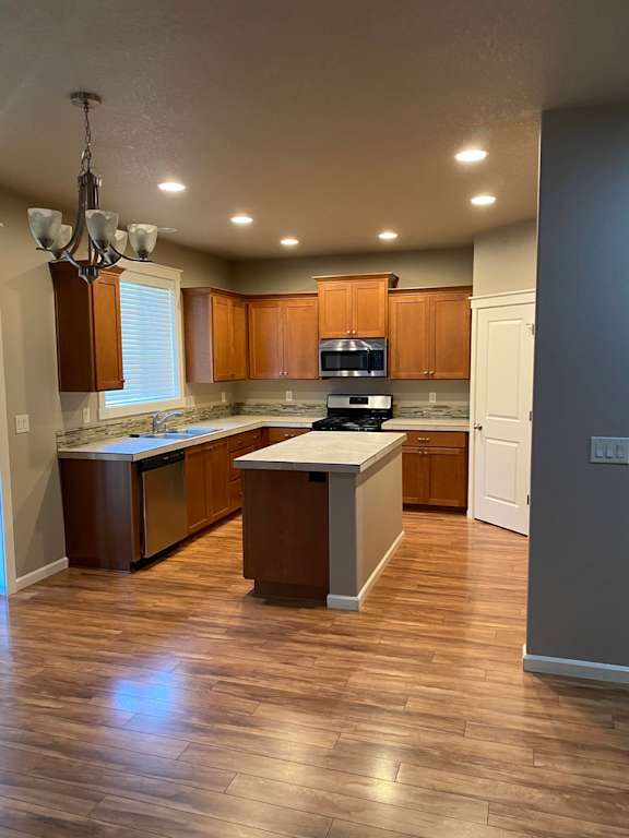 a kitchen with a center island and a stove top oven