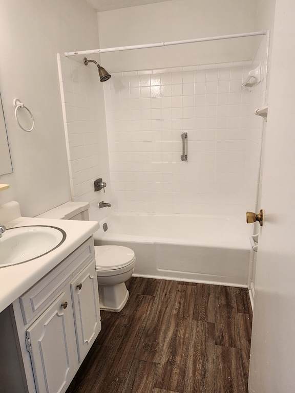 A white bathroom with a toilet, sink, and shower.
