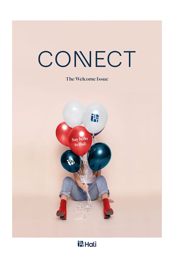 A person holding a bunch of balloons with the word "CONNECT" above them.
