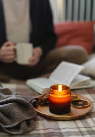 a person sitting on the floor with a candle at The Jane at Preston Trail, Cedar Hill, TX