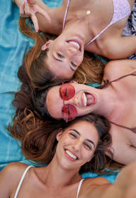 a woman with friends smiling and laying down and taking a photo at Bellary Flats, Summerville, SC 29486