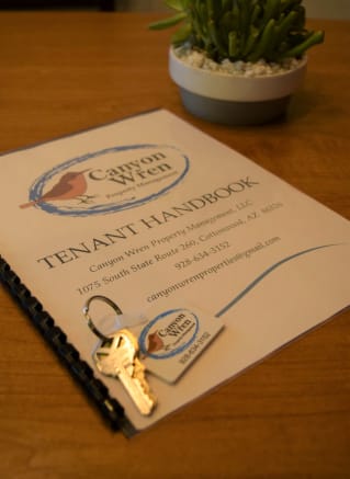 a book with a key on top of it on a table