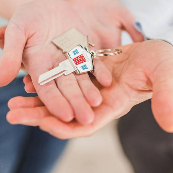 A person is holding a key in their hand.