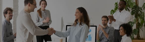 a group of people shaking hands in an office