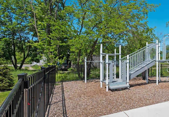 a playground with a slide and monkey bars at the preserve at great pond apartments in windsor