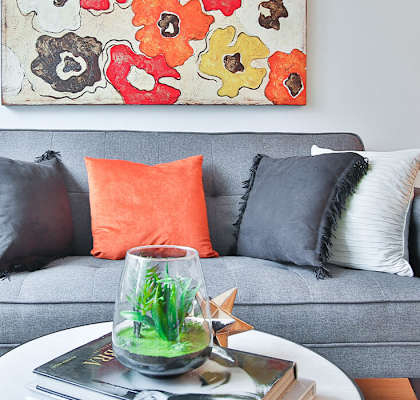 Blue couch with pillows and coffee table
