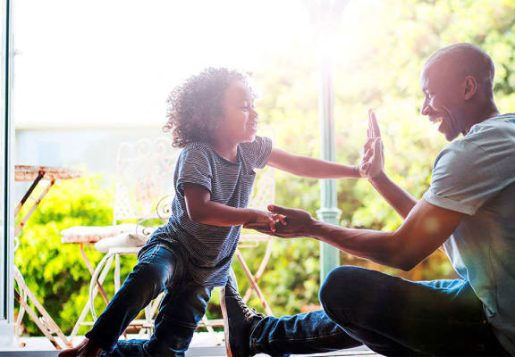 Stock photo of a dad playing with his son at Riverstone Apartments in Antioch, CA