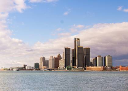 A city skyline is seen from the water.