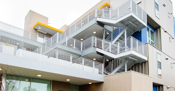 an image of an apartment building with stairs and balconies
