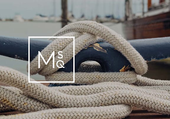 a close up of a white rope tied to a dock