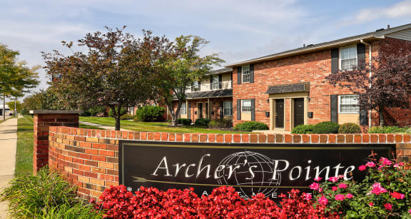 Community Entrance at Archer's Pointe with brick sign and flower beds.