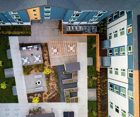 A courtyard surrounded by buildings with a table and chairs.