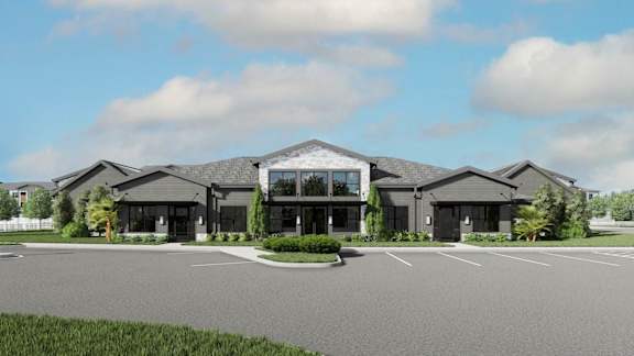 A modern building with a parking lot in front.at The Liliana Apartment Homes, Pooler, GA 31322