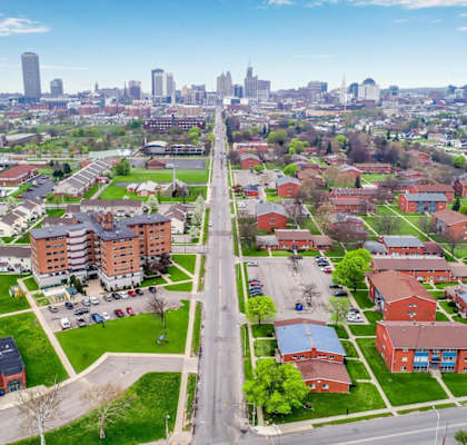 A cityscape with a mix of residential and commercial buildings.
