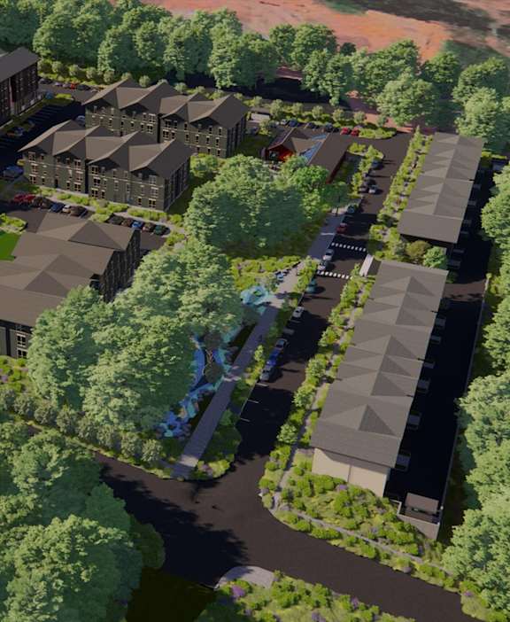 A bird's eye view of a residential area with houses surrounded by trees.