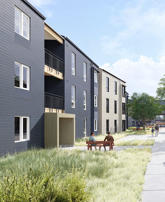 A modern apartment complex with a walkway and benches in the foreground.