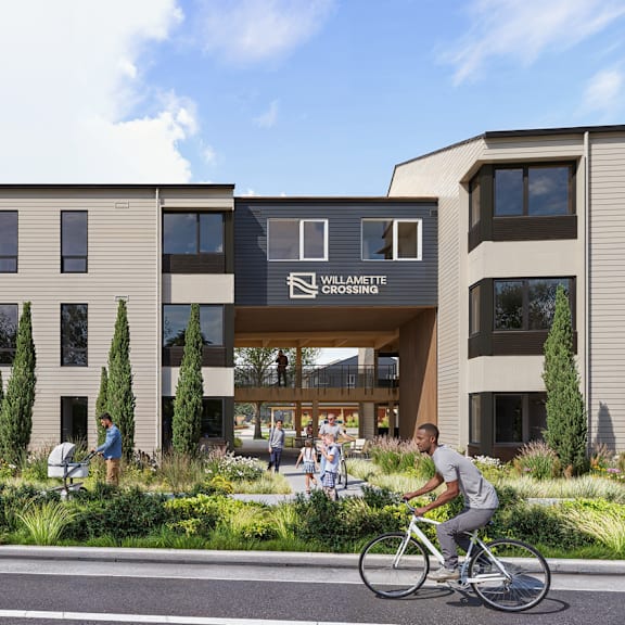 A person riding a bicycle in front of a building with a sign that reads "Willamette".